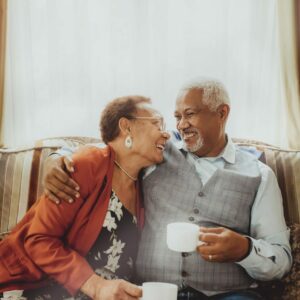 Two seniors drinking coffee together
